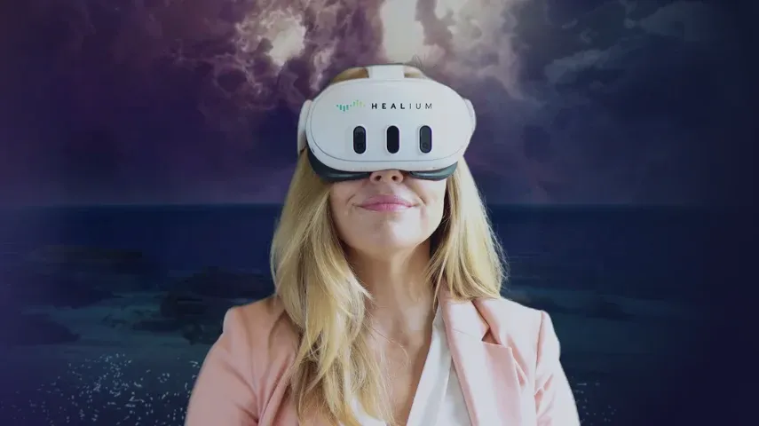 Woman wearing VR goggles experiencing a virtual beach.