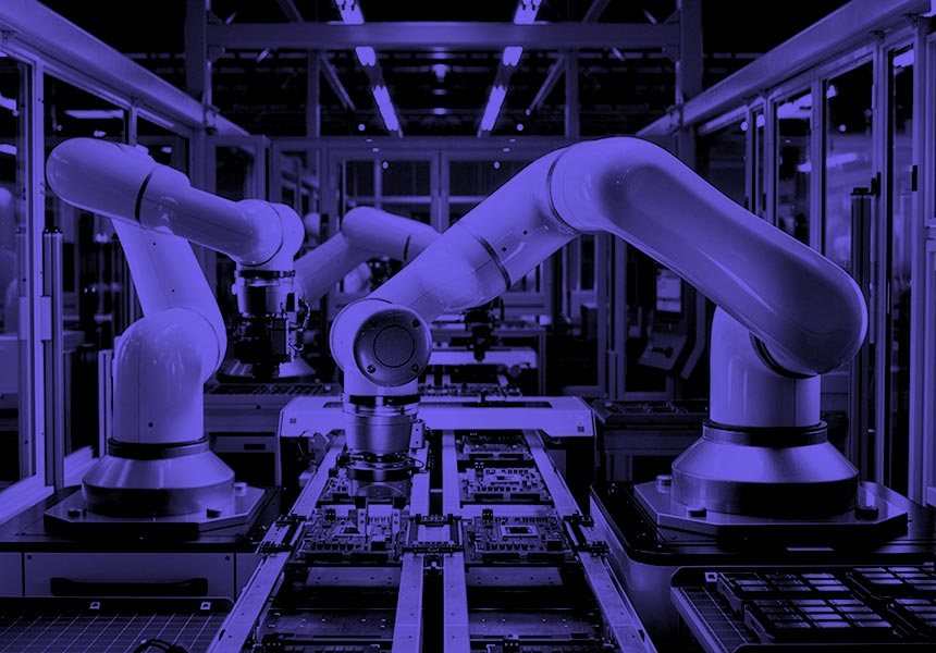 Industrial robots build computer parts on a factory assembly line.